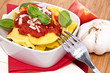 Fresh Tortellini in a bowl on wooden background
