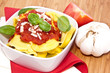 Fresh Tortellini in a bowl on wooden background