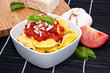 Tortellini in a bowl with ingredients