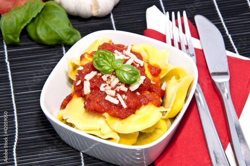 Photo: Tortellini with blurred ingredients in the background Tortellini with blurred ingredients in the background