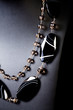 luxury jewellery black stone set necklace over black background
