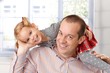 Happy father playing with little daughter