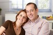 Photo: Portrait of happy couple at home Portrait of happy couple at home