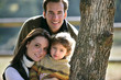 happy couple and their kid in the park