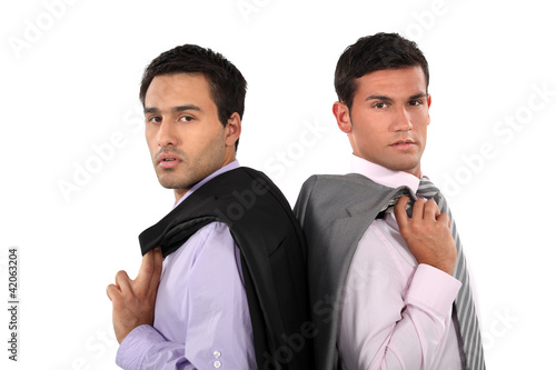 Photo: Businessmen standing back to back Businessmen standing back to back
