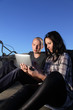 beauty girl and boy with tablet pc outdoors