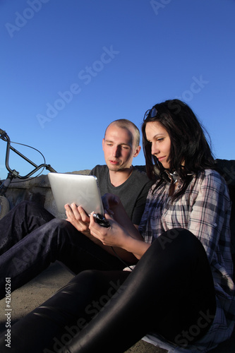 Photo: beauty girl and boy with tablet pc outdoors beauty girl and boy with tablet pc outdoors