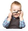 Photo: Portrait of a cute little boy wearing glasses Portrait of a cute little boy wearing glasses