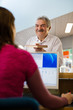 Photo: girl and senior man returning book in library girl and senior man returning book in library