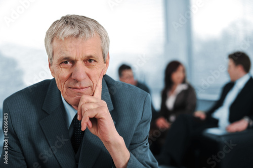 Photo: Business team with manager sitting in front Business team with manager sitting in front
