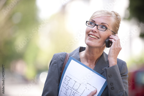 Photo: Female Real Estate Agent talking on phone Female Real Estate Agent talking on phone