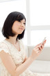 Photo: Beautiful young woman using a mobile phone. Portrait of asian. Beautiful young woman using a mobile phone. Portrait of asian.