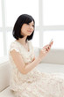 Beautiful young woman using a mobile phone. Portrait of asian.