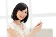 Photo: Beautiful young woman using a mobile phone. Portrait of asian. Beautiful young woman using a mobile phone. Portrait of asian.