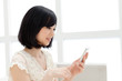 Beautiful young woman using a mobile phone. Portrait of asian.