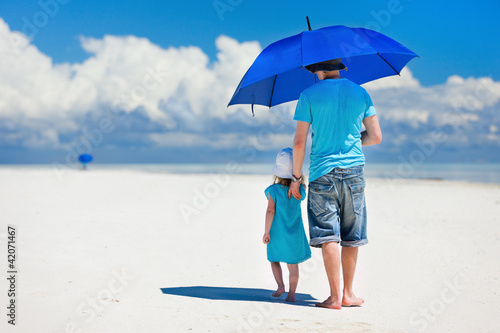 Photo: Father and daughter walking at beach Father and daughter walking at beach