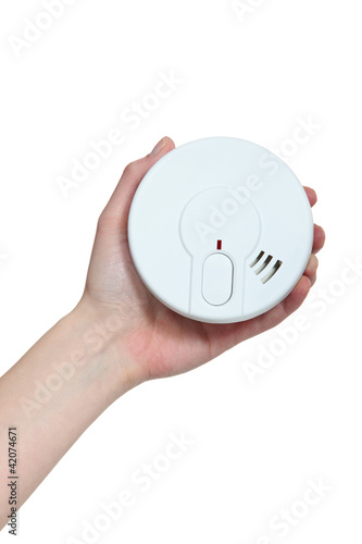 Photo: Hand holding a smoke alarm Hand holding a smoke alarm