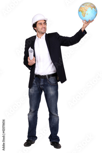 Photo: An architect holding a globe up. An architect holding a globe up.