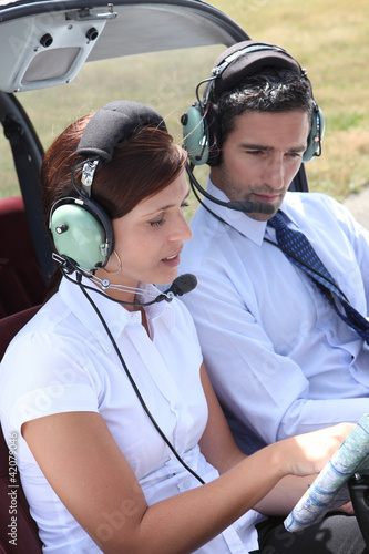 Photo: Woman setting a flight plan in an open cockpit Woman setting a flight plan in an open cockpit