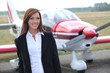 Woman in front of airplane