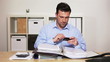 Manager using smartphone for research at work in his office