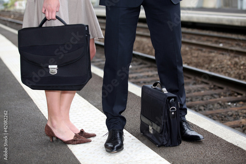 Photo: Businesspeople waiting at the trainstation Businesspeople waiting at the trainstation