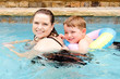 Mother and son swimming together while on vacation