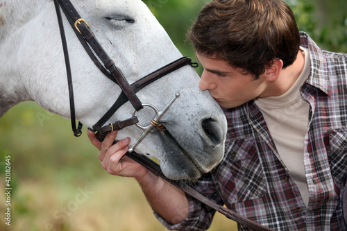 Photo: A man patting his horse A man patting his horse