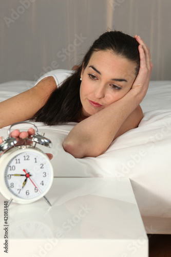 Foto: Woman stopping Alarm Woman stopping Alarm