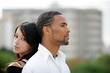 young couple in front of buildings