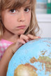 Girl pointing at globe
