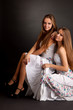 Two girls twins, isolated on the grey background