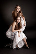 Two girls twins, isolated on the grey background