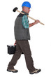 Construction worker carrying tools