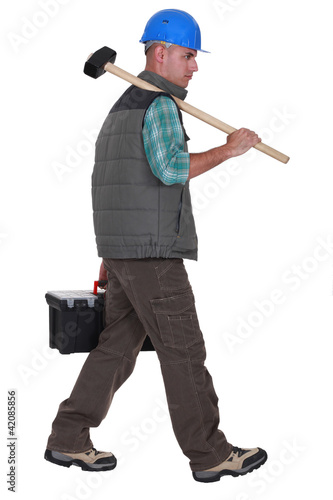 Photo: Construction worker carrying tools Construction worker carrying tools