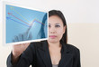 Business lady writing up graph on tablet screen.