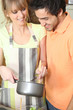 Young couple with a saucepan