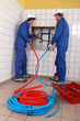 Plumbers installing new hot and cold pipes