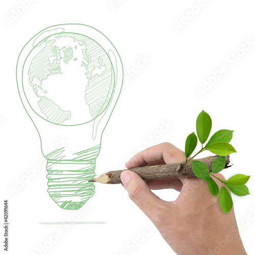 Photo: Male hand drawing Globe in a light bulb. Male hand drawing Globe in a light bulb.