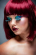 Foto: Beautiful young female with aurburn hair and blue eye makeup Beautiful young female with aurburn hair and blue eye makeup