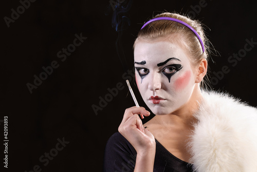 Photo: The mime with a cigarette on black background The mime with a cigarette on black background