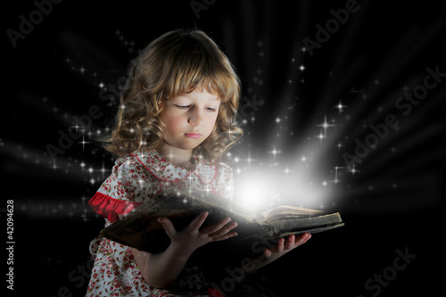 Photo: Teen girl reading the Book. Teen girl reading the Book.