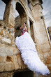 Photo: Bride. Long ruffled skirt of wedding gown cascading down Bride. Long ruffled skirt of wedding gown cascading down