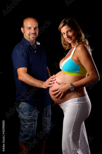 Photo: pregnant woman and husband touching her belly pregnant woman and husband touching her belly