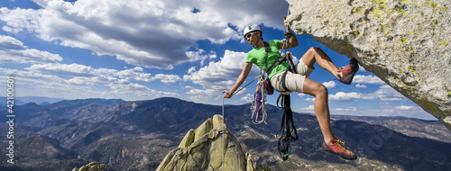 Photo: Climber rappels. Climber rappels.