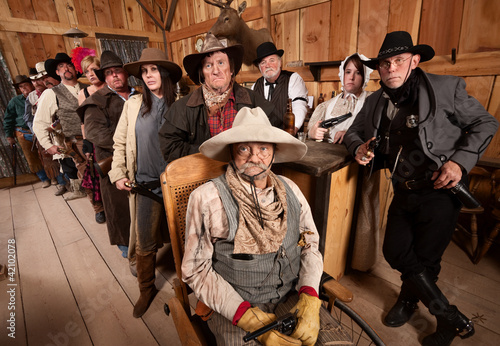 Photo: Serious Group of People in Old West Tavern Serious Group of People in Old West Tavern