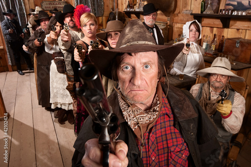 Photo: Mean Gunslinger and Customers With Weapons Mean Gunslinger and Customers With Weapons