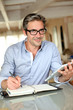 Handsome businessman with eyeglasses working from home