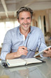 Handsome guy working from home with electronic tablet