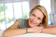 Beautiful blond mature woman relaxing in sofa
